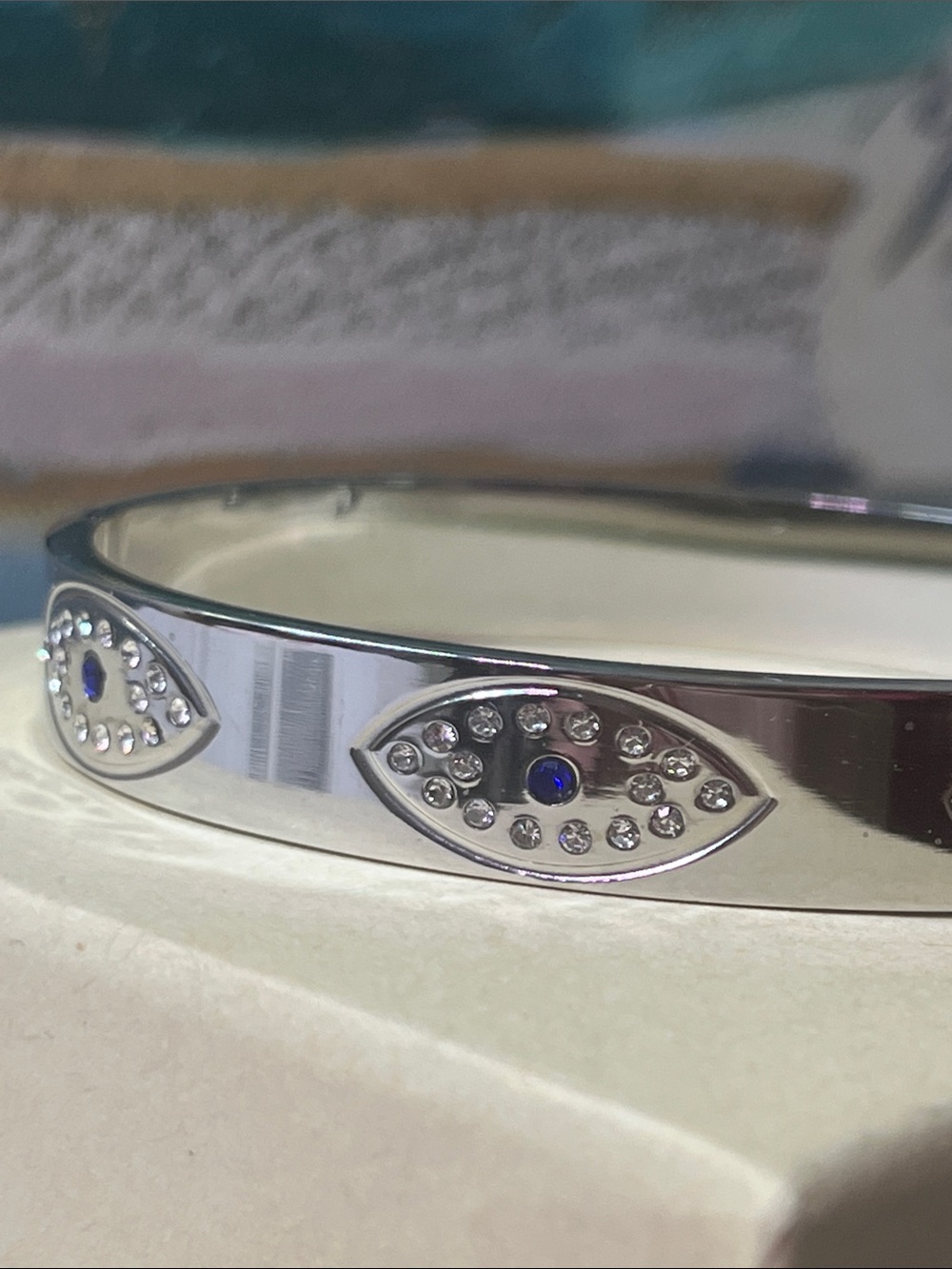 Silver Tone Evil Eye Bangle Bracelet with Sapphire Accent